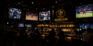 Four big screens above the bar showing football, basketball, and soccer